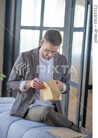 low angle, waist up, sitting, sofa, glass door, dark-haired, glasses, eyewear 59165512