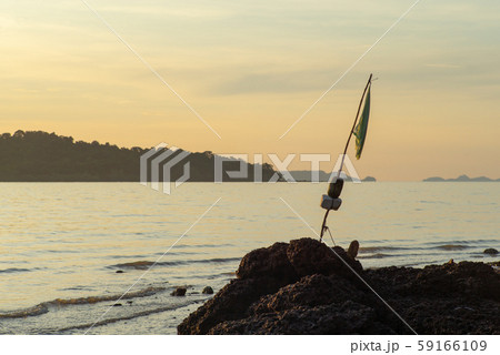 Selective focus on torn flag on old bamboo stick 59166109