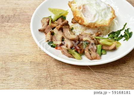 spicy stir fried slice grilled pork with chili and basil leaf topping egg on dish spicy stir fried slice grilled pork with chili and basil leaf topping egg on dish 59168181