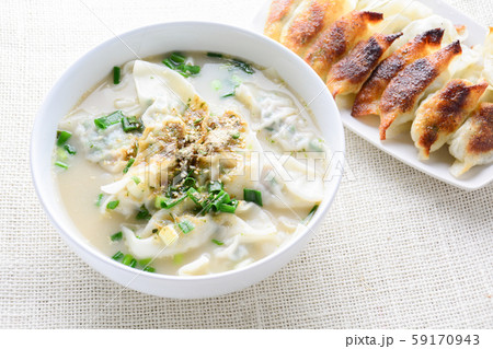 Wonton soup with spring onion served in a white Wonton soup with spring onion served in a white 59170943
