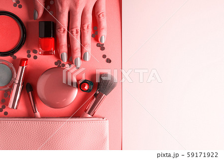 Make up items on pink coral and hand with manicure 59171922