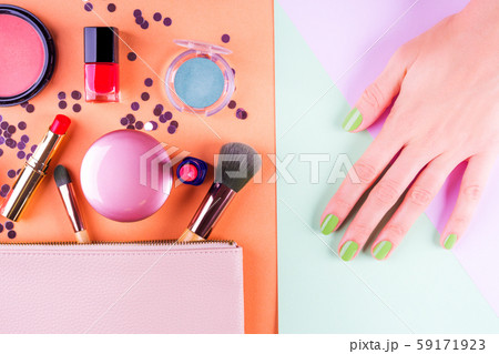 Make up items on orange and mint green. Flat lay 59171923