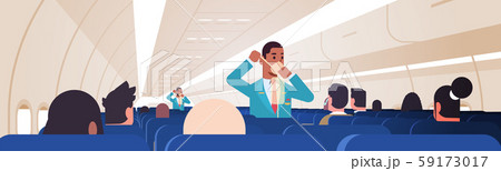 steward explaining for passengers how to use oxygen mask in emergency situation african american 59173017