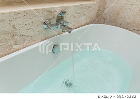 Luxury bath tub and faucet with water Luxury bath tub and faucet with water 59175232