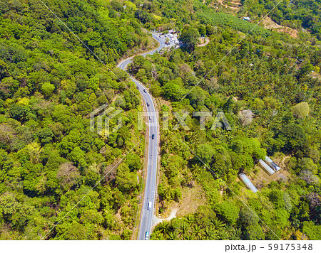 Aerial view of cars driving on curved, zigzag road Aerial view of cars driving on curved, zigzag road 59175348