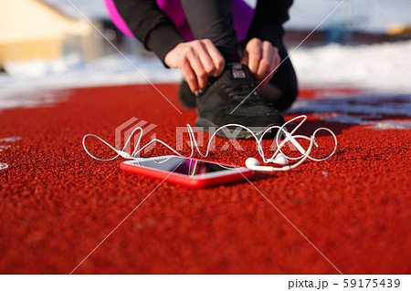 girl athlete in black sneakers, crouching on the girl athlete in black sneakers, crouching on the 59175439