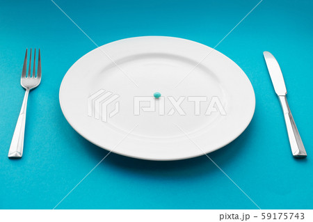 A small tablet in a plate. Medical concept. Eat 59175743