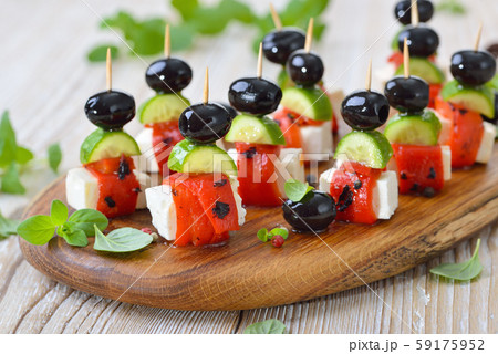 Feta cheese skewers with grilled and pickled red peppers, snack cucumbers and black olives Feta cheese skewers with grilled and pickled red peppers, snack cucumbers and black olives 59175952