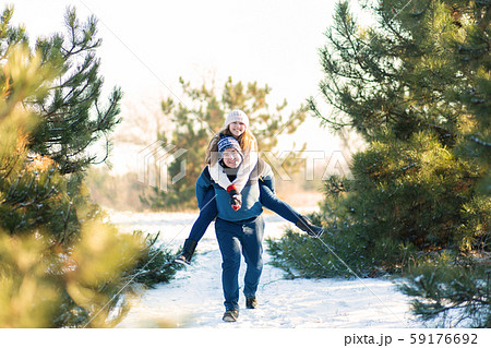Loving couple play in the winter in the forest. 59176692