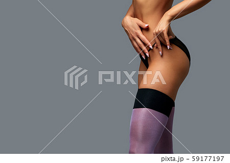 Sexy woman in stocking. The concept of corrupt bribes, tips, prostitution. Gray background, copy Sexy woman in stocking. The concept of corrupt bribes, tips, prostitution. Gray background, copy 59177197