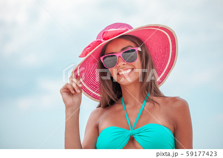 Smiling woman in sunhat 59177423