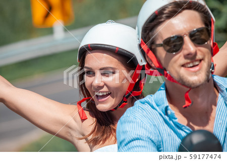 Happy couple on a scooter 59177474