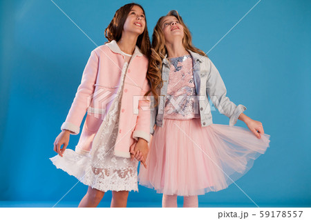 Two beautiful fashionable girl girlfriends in pink and white dresses 59178557
