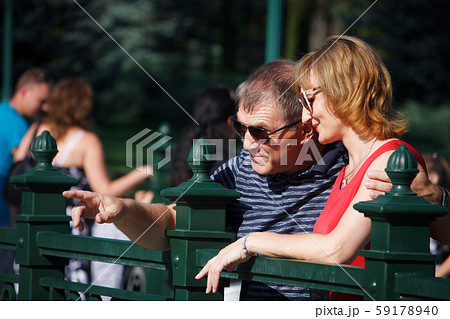 Middle-aged couple smiling and hugging on a walk Middle-aged couple smiling and hugging on a walk 59178940