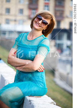 A middle-aged adult woman sits in the background A middle-aged adult woman sits in the background 59178982