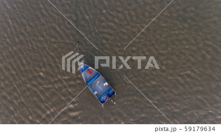 Aerial. An old fishing boat from above, on the Tejo River, in the Samouca Marina. Lisbon. Aerial. An old fishing boat from above, on the Tejo River, in the Samouca Marina. Lisbon. 59179634