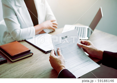 Job applicants are holding a resume document in Job applicants are holding a resume document in 59186146