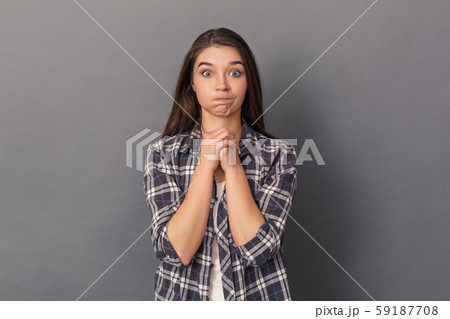Freestyle. Young woman standing studio isolated on grey warming up fists mad Freestyle. Young woman standing studio isolated on grey warming up fists mad 59187708