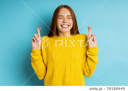 Studio shot of redhead caucasian young woman isolated blue background 59188449