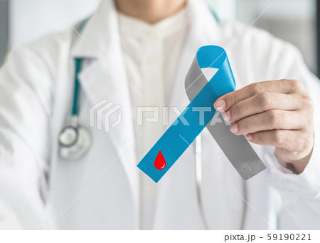Diabetes Awareness ribbon for World diabetes day with red blood drop on blue and grey bow color in doctor hand for supporting patient with diabetic type 1 disease 59190221