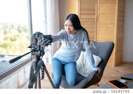 Lifestyle blogger fixing camera before making new blog Lifestyle blogger fixing camera before making new blog 59193795