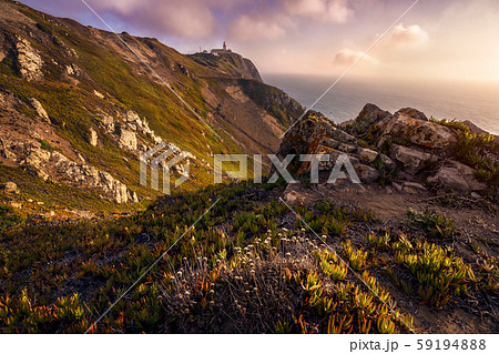 Cabo da Roca Lighthouse at sunlight and beautiful coastline hill scenery. Most westerly point of the 59194888