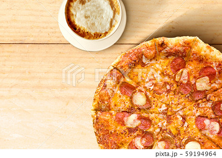 Pizza and cup of coffee on wooden table background Pizza and cup of coffee on wooden table background 59194964