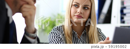 Beautiful blonde secretary sitting at workplace talking with boss Beautiful blonde secretary sitting at workplace talking with boss 59195002