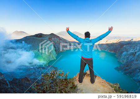 Man stand on rock above volcano Kawah Ijen acid Man stand on rock above volcano Kawah Ijen acid 59196819