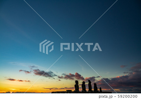 Moai shilouettes in the Ahu Tahai at sunset clear sky 59200200