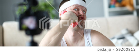 Funny Vlogger Joking and Put Dumbbell to Face Funny Vlogger Joking and Put Dumbbell to Face 59200815