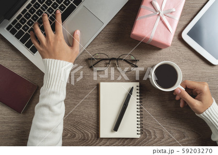 Woman hands in sweater using laptop computer. Woman hands in sweater using laptop computer. 59203270