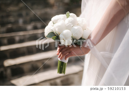 Close up of brides hands with wedding bouquet Close up of brides hands with wedding bouquet 59210153