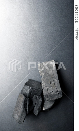 Close-up images of black color charcoal on black background that made from natural wood which represent energy power concept or healthy or use for absorb odor in the room or refrigerator. Close-up images of black color charcoal on black background that made from natural wood which represent energy power concept or healthy or use for absorb odor in the room or refrigerator. 59211008