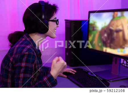 Excited gamer girl rejoicing, winning in video game 59212108