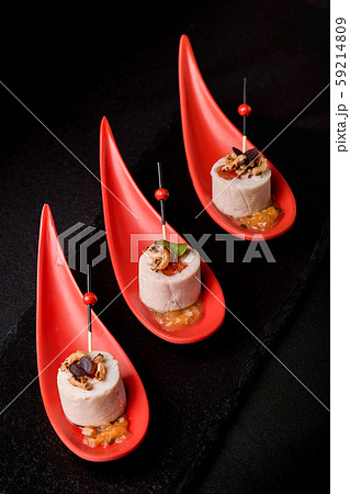 Goose liver pate, foie gras, served on black stone in Japanese red spoons. Paste served with jam and 59214809
