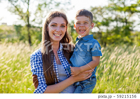 Portrait of a beautiful woman with her son on a walk in nature 59215156