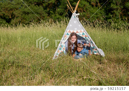Beautiful woman with her son on a picnic 59215157