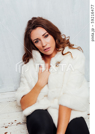 portrait of a beautiful fashionable woman with curls in a white fur coat portrait of a beautiful fashionable woman with curls in a white fur coat 59216477