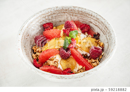 granola with banana and raspberries granola with banana and raspberries 59218882
