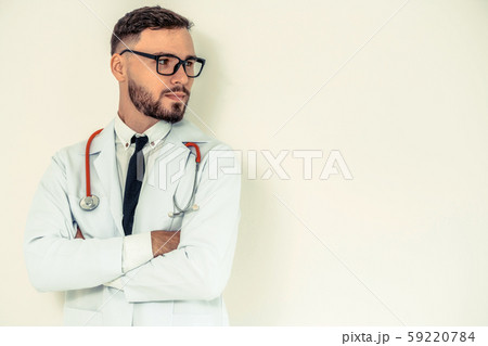 Young doctor with arms cross on white background. 59220784