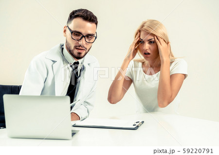 Male Doctor and Female Patient in Hospital Office 59220791