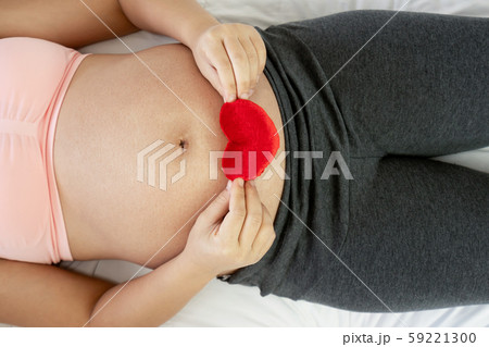 Happy pregnant woman and expecting baby at home. Happy pregnant woman and expecting baby at home. 59221300