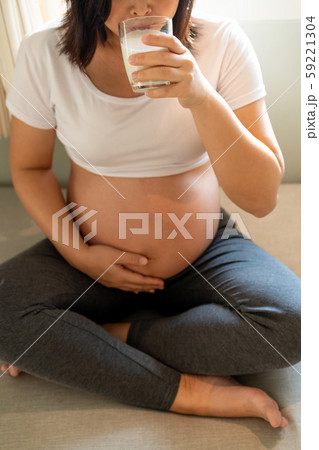 Happy pregnant woman and expecting baby at home. 59221304
