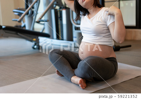 Active pregnant woman exercise in fitness center. Active pregnant woman exercise in fitness center. 59221352