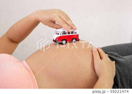 Happy pregnant woman and expecting baby at home. Happy pregnant woman and expecting baby at home. 59221474