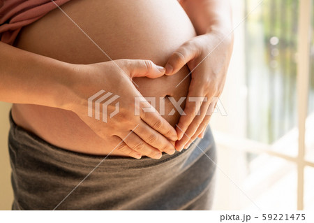 Happy pregnant woman and expecting baby at home. Happy pregnant woman and expecting baby at home. 59221475