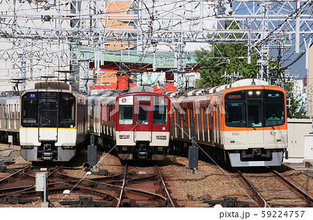 尼崎駅で並ぶ阪神近鉄電車の写真素材