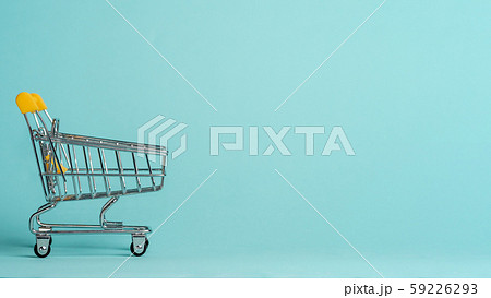 Shopping cart staggered on blue, copy space 59226293