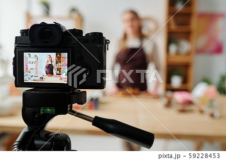 Contemporary girl on display of home camera recording soap making master class Contemporary girl on display of home camera recording soap making master class 59228453